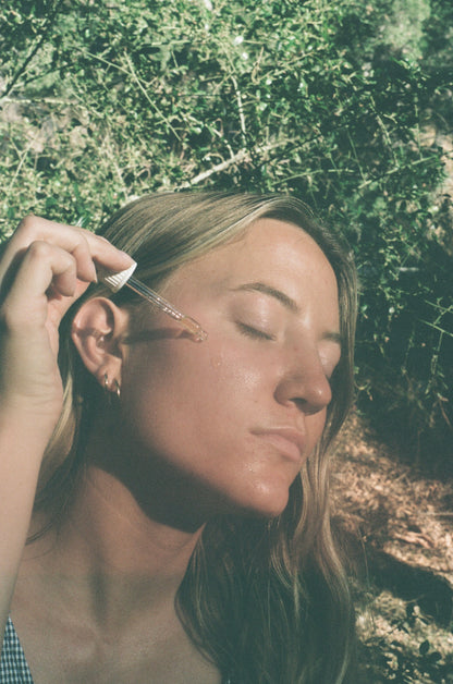 
Applying Luteal / Menstrual Serum to the cheek outdoors